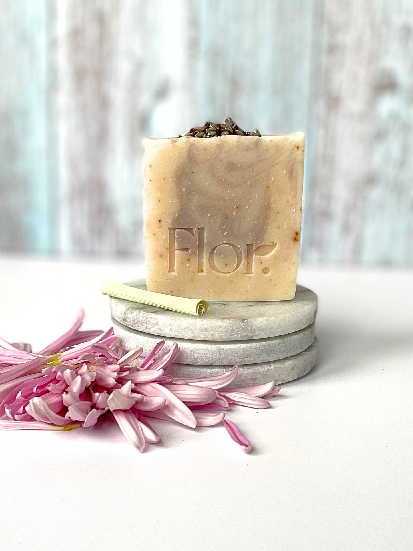 Handmade soap bar with dried lemon peel and dried lavender flower decorated with fried lavender flower on the top of the soap bar and it has purple swirls in the bar created by purple Brazilian clay. Vegan soap. Handmade soap UK. Made by a handmade soap company based in Scotland, UK.