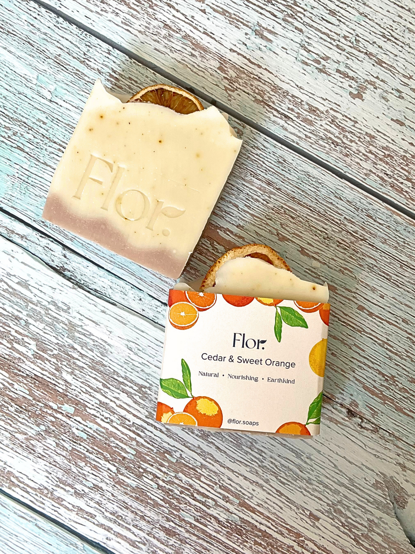 Natural handmade soap bars used for vegan and natural skincare.  Cedar and Sweet Orange essential oils and home dried orange peel provide a high amount of vitmain c which is great for the skin, making it appear younger looking, plumper and smoother. The soap is wrapped in a beautiful soap label illustrated with bespoke orange illustrations.  Handemade soap UK. Vegan soap. Made by a handmade soap company based in Scotland, UK.